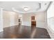 Bright open-plan room with hardwood floors, white trim, and connecting view to kitchen at 4352 Haddington Dr, Fort Mill, SC 29707