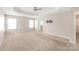 Spacious main bedroom featuring multiple windows, plush carpet, and access to the ensuite bathroom at 4352 Haddington Dr, Fort Mill, SC 29707