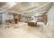 Spacious unfinished basement with brick fireplace, pool table, and ample storage space at 4630 Woodleaf Rd, Salisbury, NC 28147
