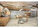 Unfinished basement with work table, shelving, and exposed utilities for potential customization at 4630 Woodleaf Rd, Salisbury, NC 28147