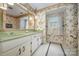 Charming bathroom with green countertop, botanical wallpaper, and ample natural light at 4630 Woodleaf Rd, Salisbury, NC 28147