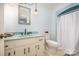 Bright bathroom with vanity, faucet, mirror, toilet, and walk-in shower behind a curtain at 4630 Woodleaf Rd, Salisbury, NC 28147