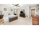 Spacious bedroom with a ceiling fan, neutral walls, carpet, and a chest at the foot of the bed at 4630 Woodleaf Rd, Salisbury, NC 28147