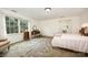 Comfortable bedroom featuring natural light, carpet, and vanity with mirror and stool at 4630 Woodleaf Rd, Salisbury, NC 28147