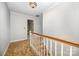 Upstairs hallway with patterned carpet, a stair railing, and light-colored walls at 4630 Woodleaf Rd, Salisbury, NC 28147
