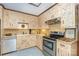 Cozy kitchen featuring neutral cabinets, stainless steel appliances, and a bright, inviting atmosphere at 4630 Woodleaf Rd, Salisbury, NC 28147