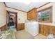 Functional laundry room with wood paneling, tile accents, and a washer/dryer set at 4630 Woodleaf Rd, Salisbury, NC 28147
