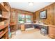 Office with wood paneling, large window overlooking landscaped lawn, built-in shelves, and ample workspace at 4630 Woodleaf Rd, Salisbury, NC 28147