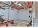 Unfinished basement with exposed beams and block walls, presenting a blank canvas for customization and storage at 466 Shiloh Church Rd, Hickory, NC 28601