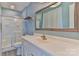 Bright bathroom featuring a sleek vanity, framed mirror, and a glass-enclosed shower at 466 Shiloh Church Rd, Hickory, NC 28601