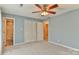 Cozy bedroom featuring neutral carpet, a ceiling fan, and a closet at 466 Shiloh Church Rd, Hickory, NC 28601