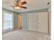Cozy bedroom featuring neutral carpet, a ceiling fan, and a closet at 466 Shiloh Church Rd, Hickory, NC 28601