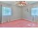 Standard bedroom featuring a ceiling fan, pink carpet, and two windows at 466 Shiloh Church Rd, Hickory, NC 28601