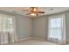 Cozy bedroom featuring neutral carpet, a ceiling fan, and two windows at 466 Shiloh Church Rd, Hickory, NC 28601