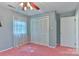 Standard bedroom featuring a ceiling fan, closet, and pink carpet at 466 Shiloh Church Rd, Hickory, NC 28601