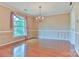 Bright dining room with hardwood floors, chandelier, and a large window offering natural light at 466 Shiloh Church Rd, Hickory, NC 28601