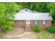 Classic brick home with mature trees, a metal roof and a cozy curb appeal at 466 Shiloh Church Rd, Hickory, NC 28601