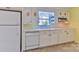 Kitchen featuring white cabinets, stone tile flooring, and modern appliances at 466 Shiloh Church Rd, Hickory, NC 28601