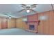 Spacious living room with a brick fireplace, wood paneling and two ceiling fans at 466 Shiloh Church Rd, Hickory, NC 28601