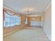 Open living area with carpet flooring and large windows for natural light, chandeliers and trim at 466 Shiloh Church Rd, Hickory, NC 28601