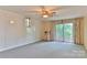 Bright living room with sliding glass doors and a vintage ceiling fan at 466 Shiloh Church Rd, Hickory, NC 28601