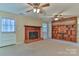 Living room features a fireplace, built-in shelving, carpet, and ceiling fans at 466 Shiloh Church Rd, Hickory, NC 28601