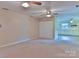 Neutral living room leading into the kitchen area, with ceiling fans and wall paneling at 466 Shiloh Church Rd, Hickory, NC 28601