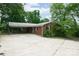 Brick home with covered parking featuring a spacious concrete patio at 466 Shiloh Church Rd, Hickory, NC 28601