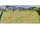 A spacious, grassy backyard with a black fence and patio, perfect for outdoor activities and relaxation at 4689 Kingswood Dr, Indian Land, SC 29707