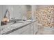Bright bathroom featuring a double vanity with granite countertops and a patterned shower curtain at 4689 Kingswood Dr, Indian Land, SC 29707