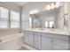 Contemporary bathroom with a double vanity, soaking tub, and bright natural light at 4689 Kingswood Dr, Indian Land, SC 29707