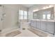 Modern bathroom featuring double vanity, large mirror, walk-in shower, and a soaking tub at 4689 Kingswood Dr, Indian Land, SC 29707