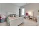 Charming bedroom with a white bed frame, toys, and a large window at 4689 Kingswood Dr, Indian Land, SC 29707