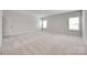 Expansive bonus room with neutral tones, plush carpet, and ample natural light at 4689 Kingswood Dr, Indian Land, SC 29707