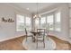 Charming dining area with a round table, neutral rug, and large windows that provide backyard view at 4689 Kingswood Dr, Indian Land, SC 29707