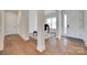 Elegant foyer showcasing beautiful hardwood floors, white trim, and access to various rooms at 4689 Kingswood Dr, Indian Land, SC 29707