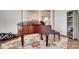 Living room featuring a piano, wainscotting, and decorative rug on hardwood floor at 4689 Kingswood Dr, Indian Land, SC 29707