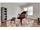 Cozy living area with a grand piano, area rug, and natural light from a window at 4689 Kingswood Dr, Indian Land, SC 29707