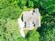 Aerial view of a home nestled among lush, mature trees in a peaceful setting at 4715 Lenden Hall Ct, Gastonia, NC 28056