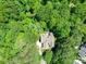 Aerial view of a charming home surrounded by lush, green trees at 4715 Lenden Hall Ct, Gastonia, NC 28056