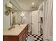 Elegant bathroom with a black and white tiled floor, and a long vanity with double sinks at 4715 Lenden Hall Ct, Gastonia, NC 28056
