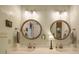 Bathroom featuring double sinks, decorative round mirrors, updated lighting, and neutral colors at 4715 Lenden Hall Ct, Gastonia, NC 28056
