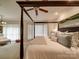 Bright bedroom boasts a dark, four-poster bed, neutral decor, and large windows at 4715 Lenden Hall Ct, Gastonia, NC 28056