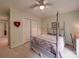 Bright bedroom featuring a four-poster bed, ceiling fan, and neutral decor at 4715 Lenden Hall Ct, Gastonia, NC 28056