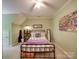 Cozy bedroom featuring a bed, large window, a ceiling fan, and neutral decor at 4715 Lenden Hall Ct, Gastonia, NC 28056