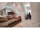 Bonus room includes a comfortable sofa, built-in shelving, and natural light from the windows at 4715 Lenden Hall Ct, Gastonia, NC 28056