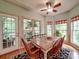 Cozy breakfast area with bright windows, a view to a screened-in porch, and a ceiling fan at 4715 Lenden Hall Ct, Gastonia, NC 28056