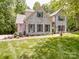 Charming white brick home with an attached garage, blue shutters, and manicured landscaping at 4715 Lenden Hall Ct, Gastonia, NC 28056