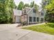White brick home with attached garage, blue shutters, manicured lawn, and concrete driveway at 4715 Lenden Hall Ct, Gastonia, NC 28056