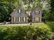 Charming white brick home with blue shutters, lush lawn, and manicured landscaping at 4715 Lenden Hall Ct, Gastonia, NC 28056